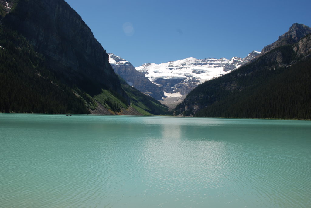 a body of water with mountains in the background with Lake Louise in the background