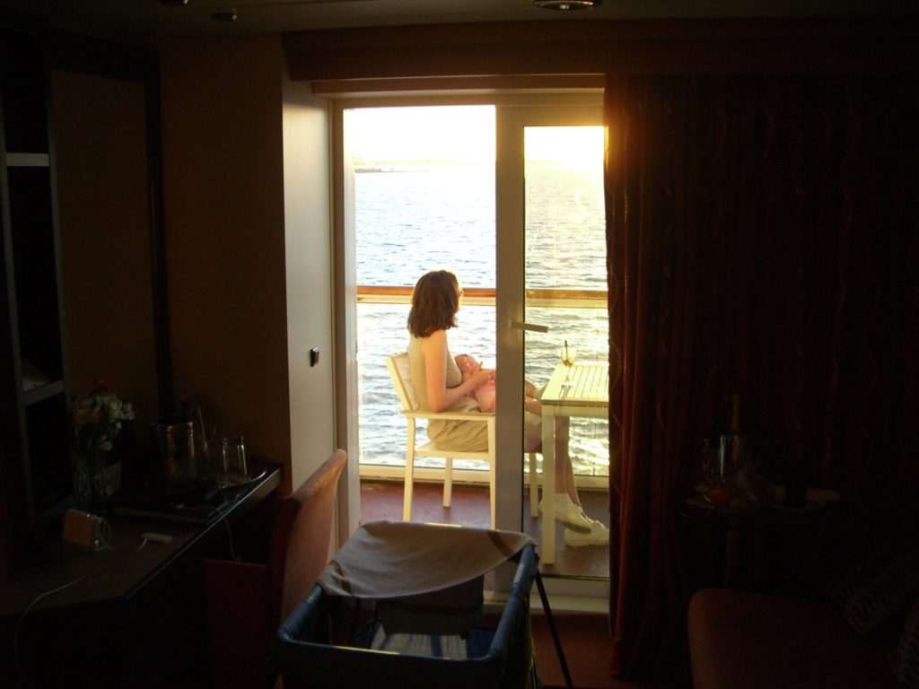 a woman sitting at a table looking out a window