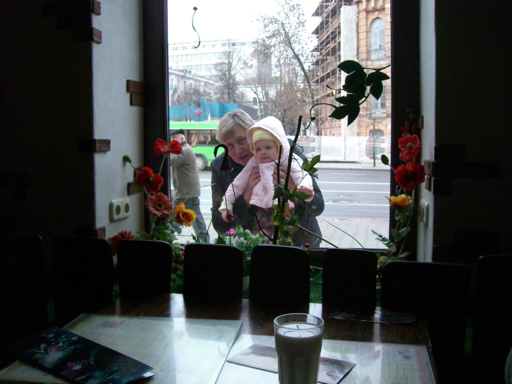 a woman and a child looking out a window
