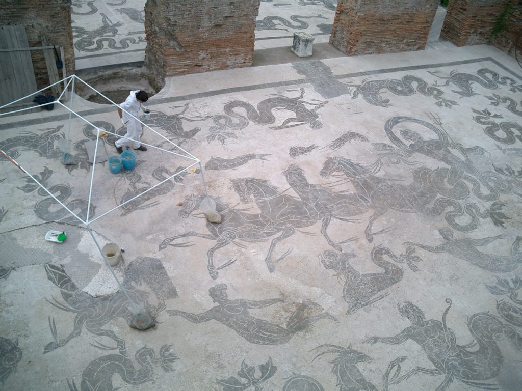 a person painting a mosaic