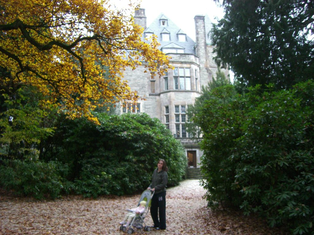a woman standing in front of a large building
