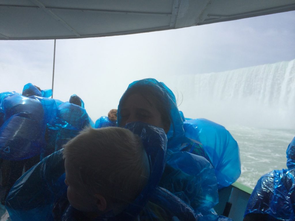 a group of people in plastic bags on a boat