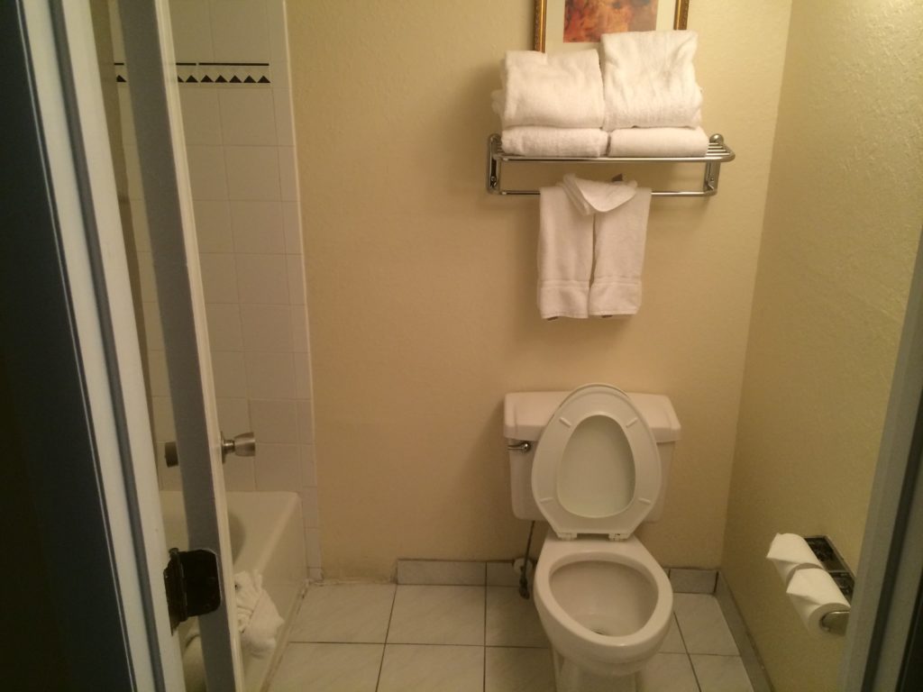 a bathroom with a toilet and towels