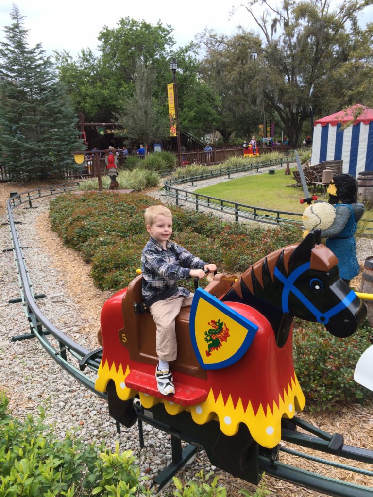 a boy riding a toy horse