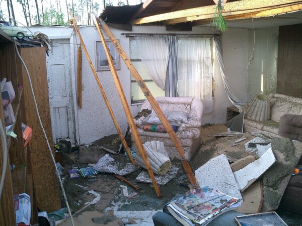 a room with a broken floor and debris