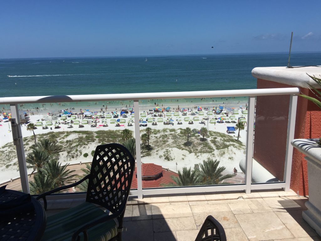 a balcony overlooking a beach and ocean