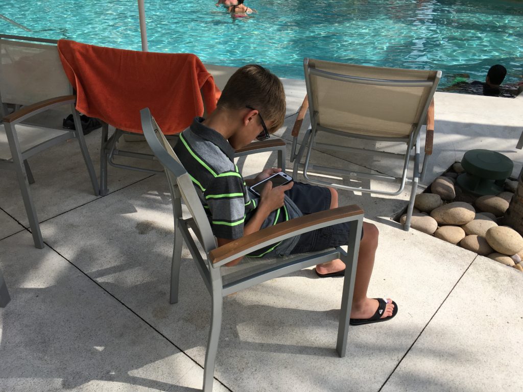 Phone time by the pool on vacation