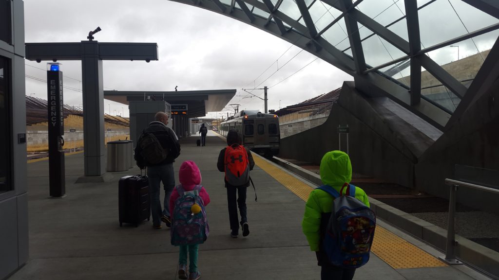 a group of people walking at a train station