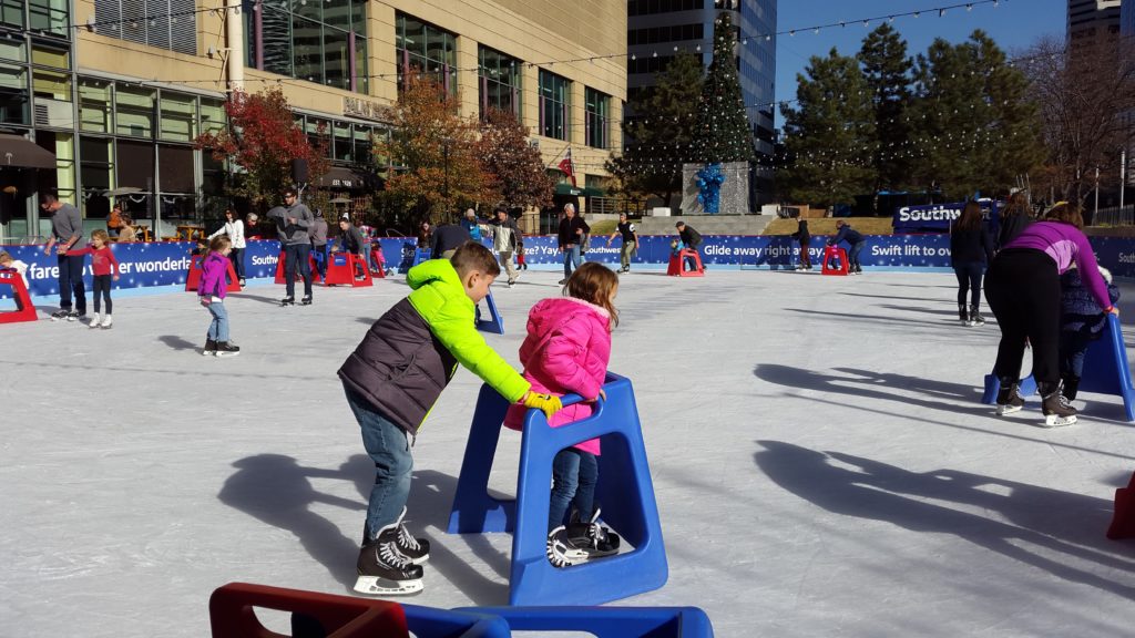 a boy and girl on ice skating rink