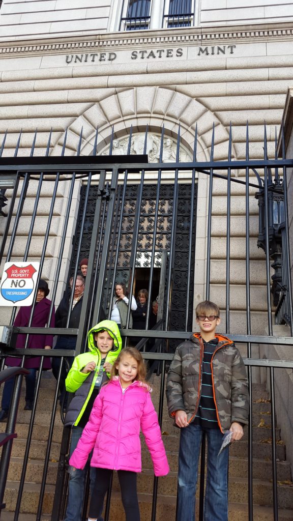 a group of kids standing in front of a gate