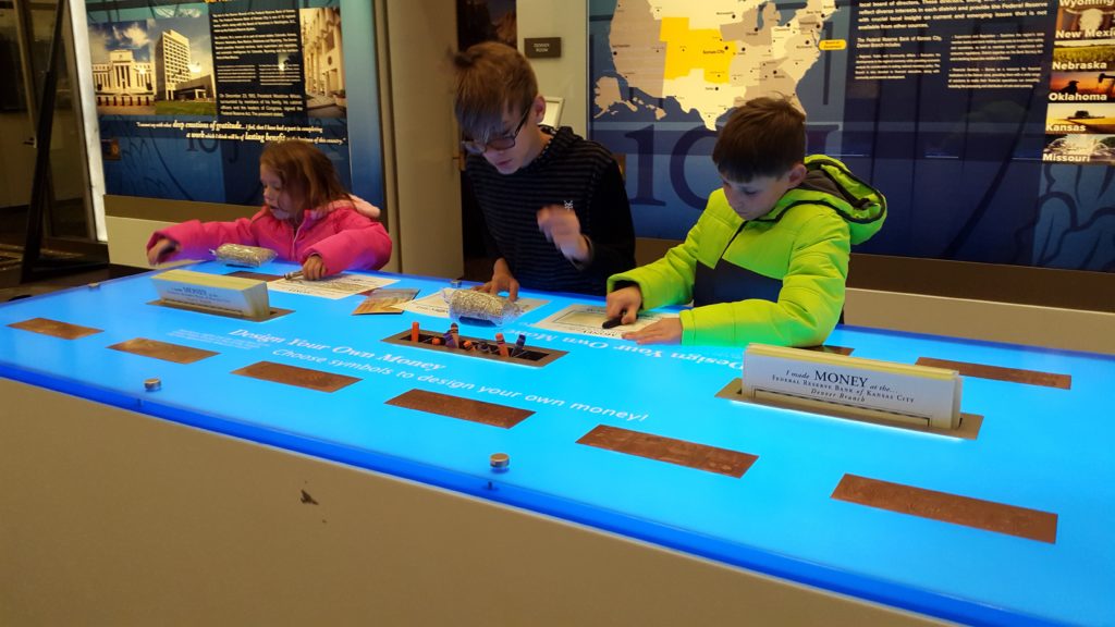 a group of kids playing with a blue table