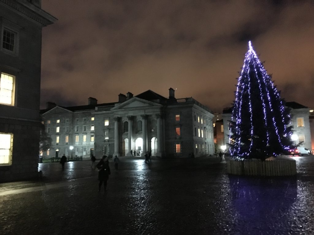 a large building with a christmas tree in front of it