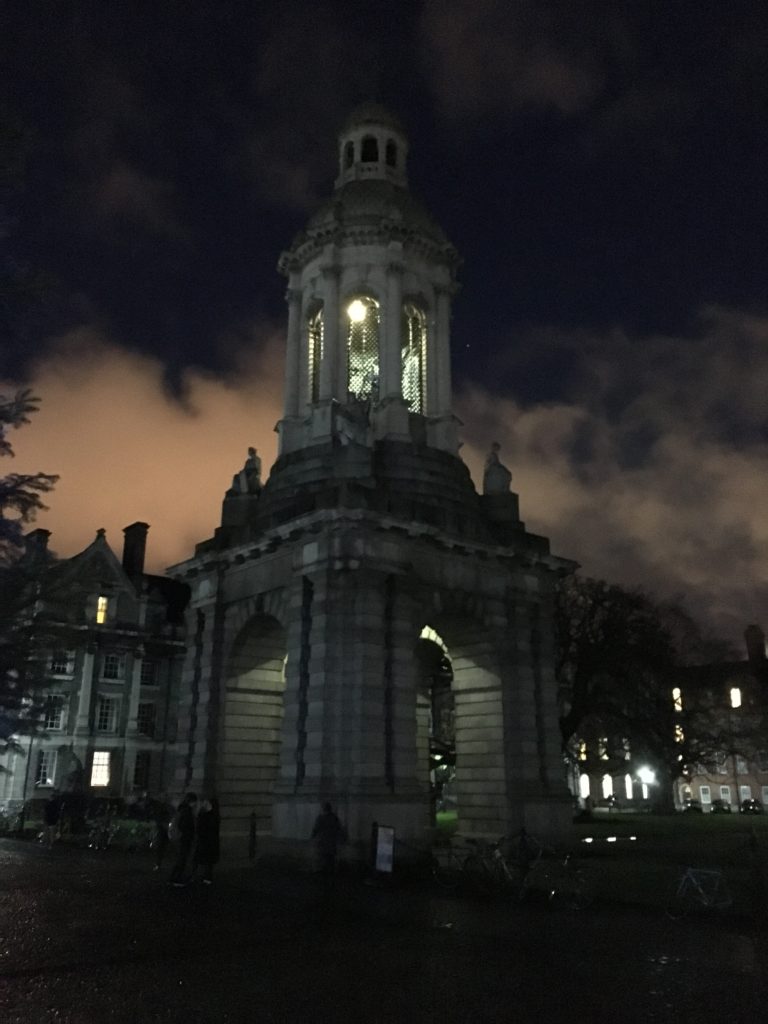 a stone building with a bell tower at night