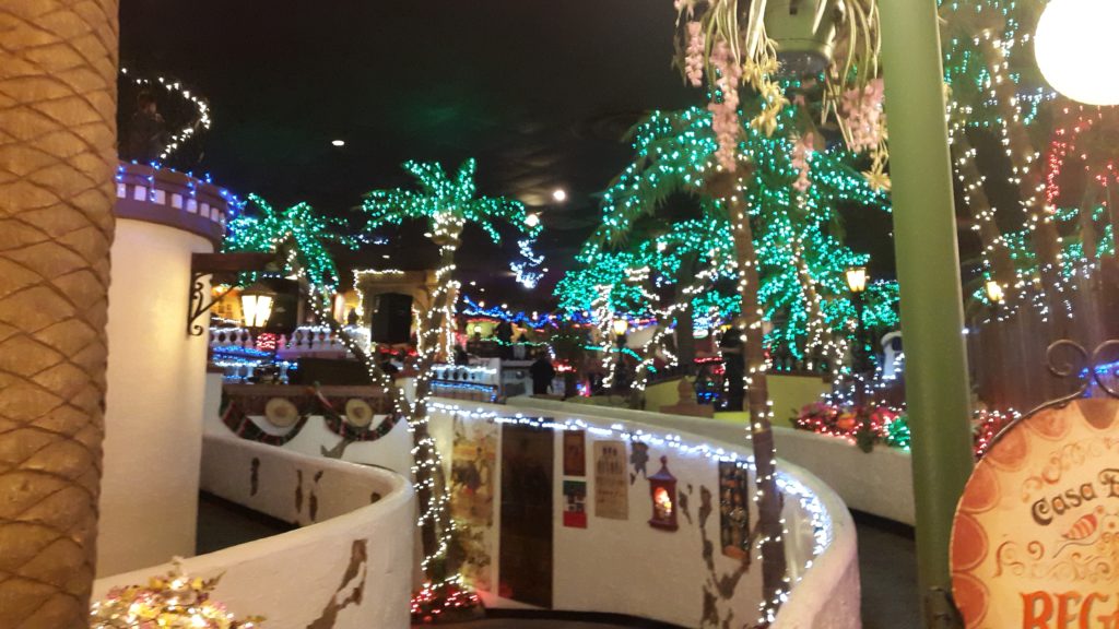 a room with palm trees and lights