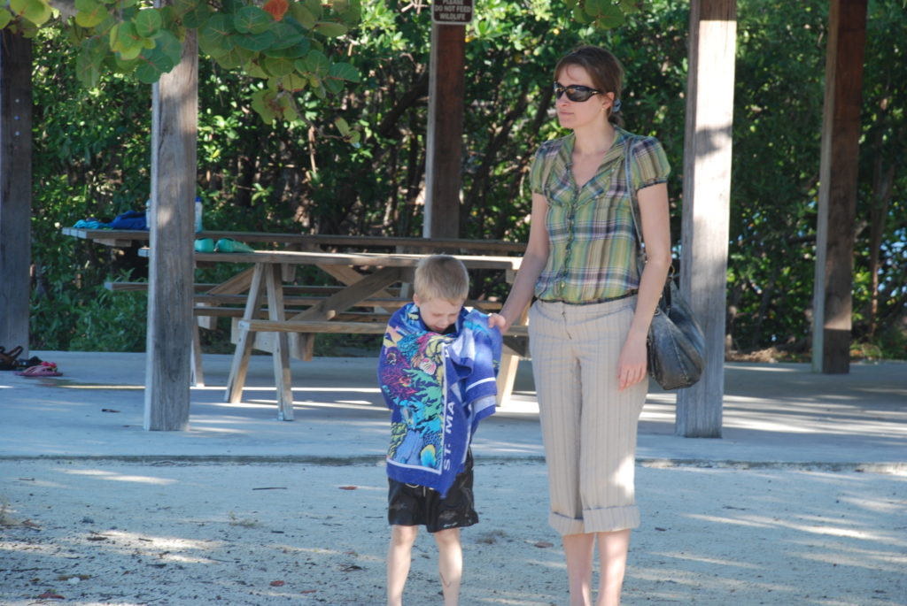 a woman holding a child's hand