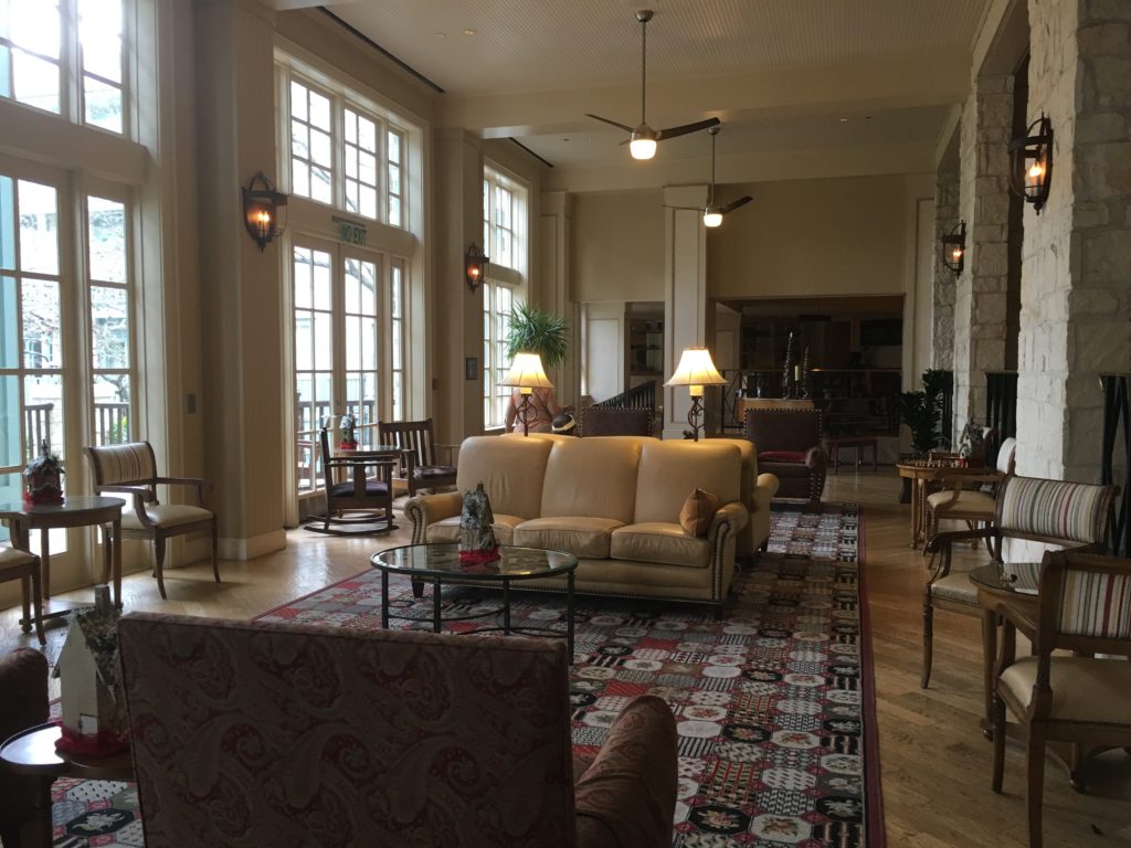 a room with a couch and chairs