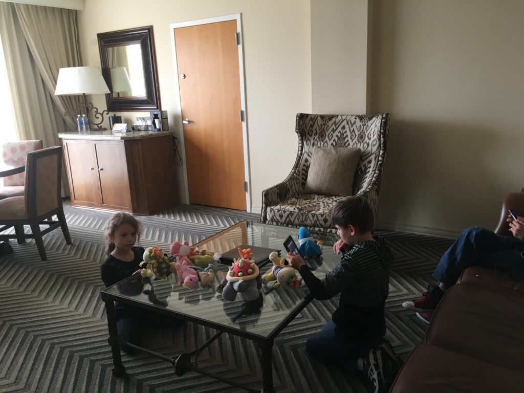 a group of kids playing with stuffed animals on a glass table