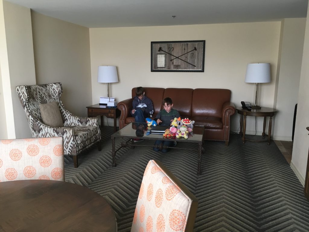 two boys sitting on a couch in a living room