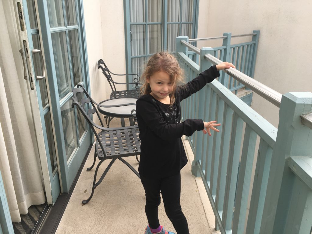 a girl standing on a balcony