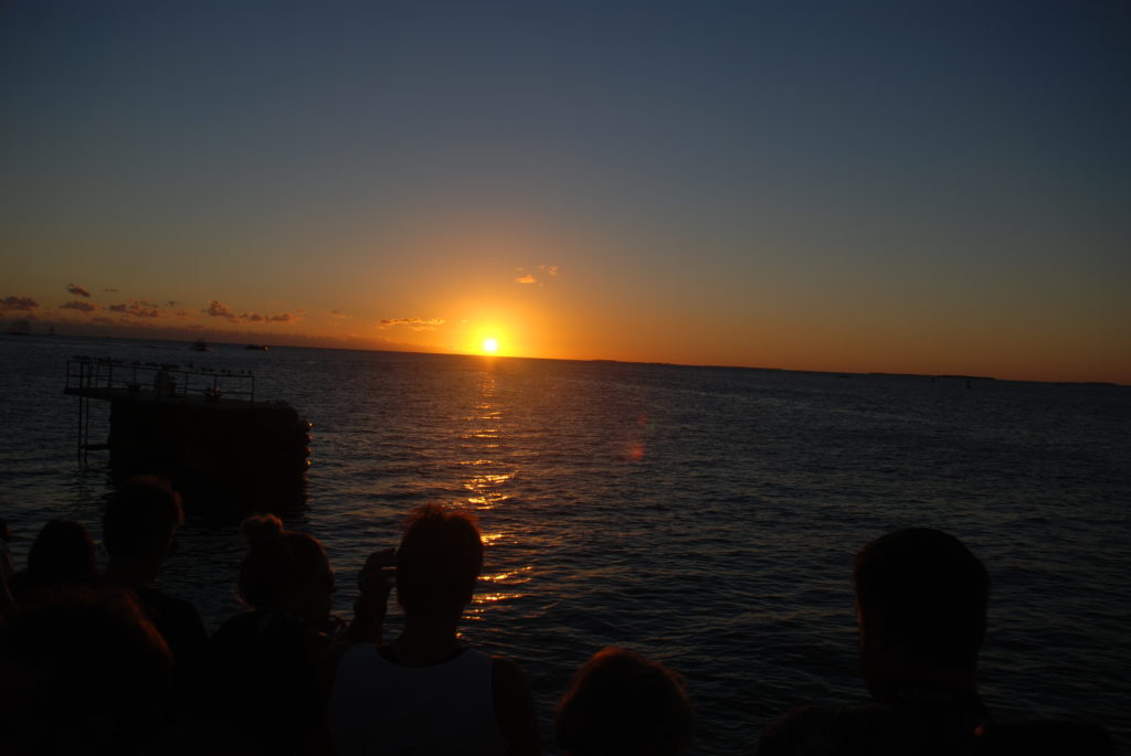 a group of people looking at the sunset