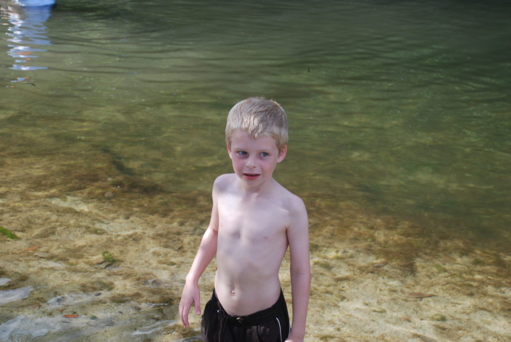a boy standing in water