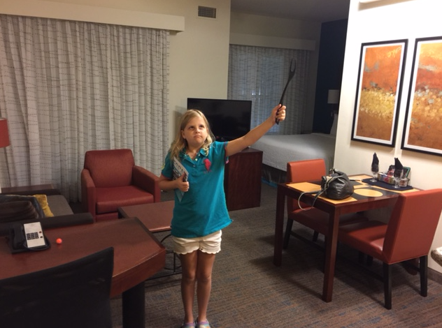 a girl holding a black object in her hand