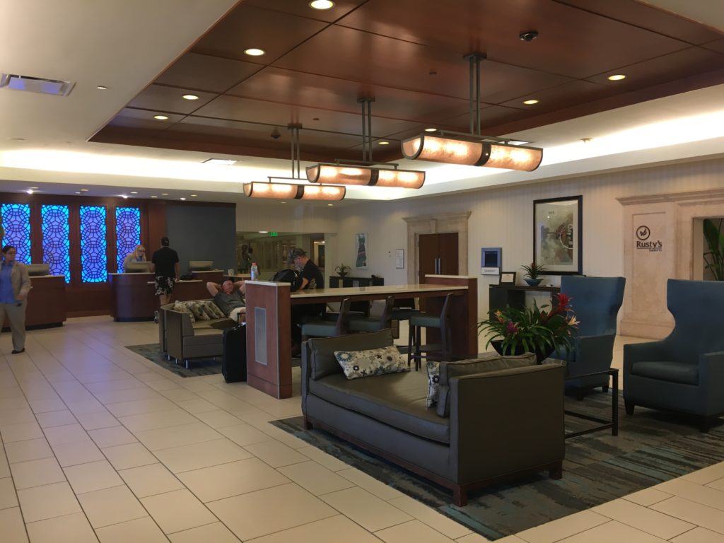a lobby with a couple of people sitting in a lounge area
