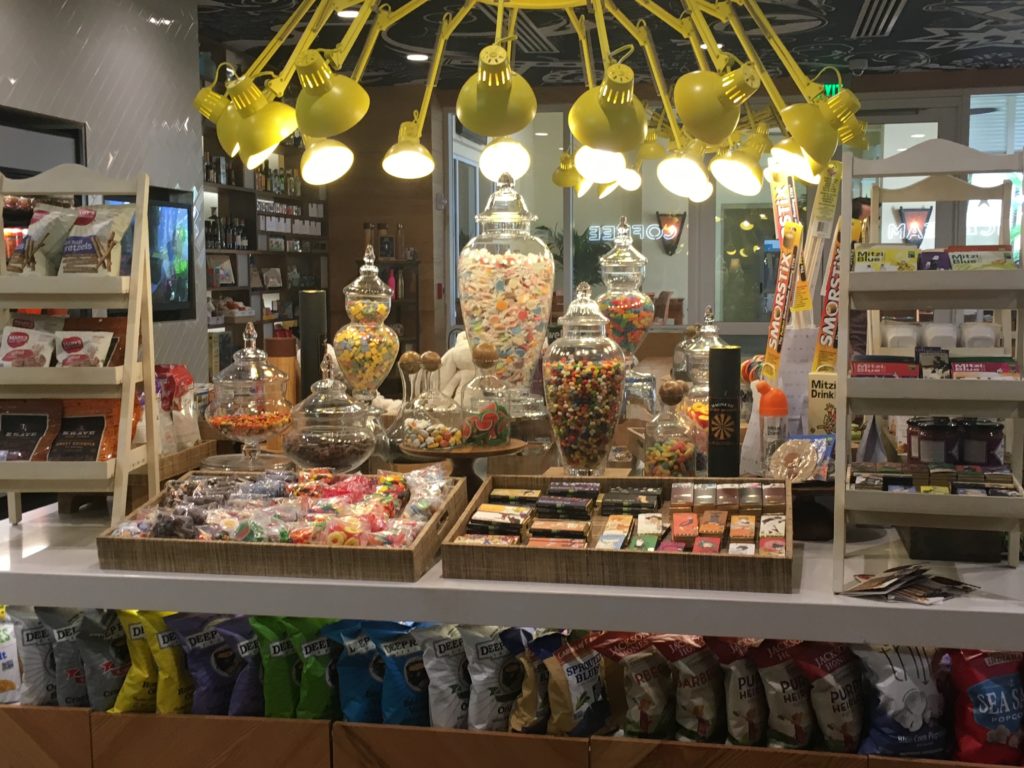 a candy store with lights from ceiling