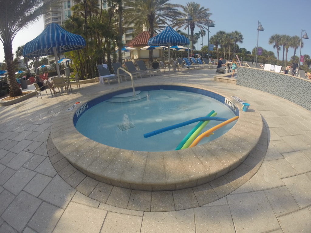a pool with blue umbrellas and umbrellas