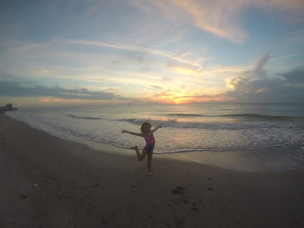 a girl standing on a beach