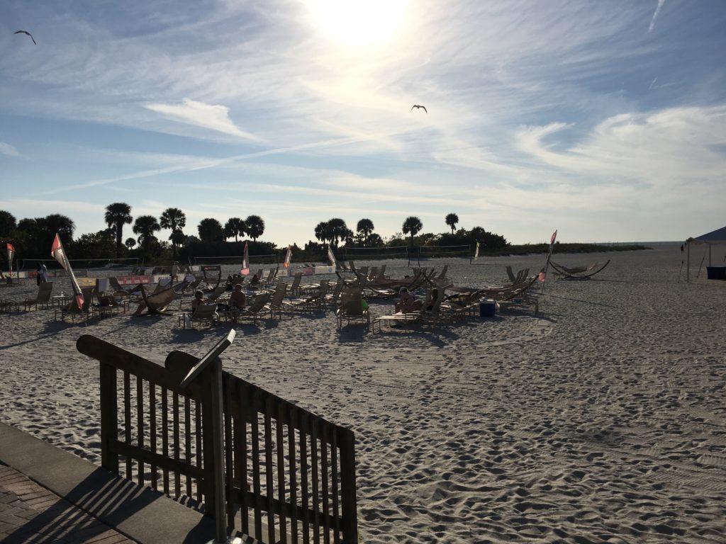 a beach with many chairs and a staircase