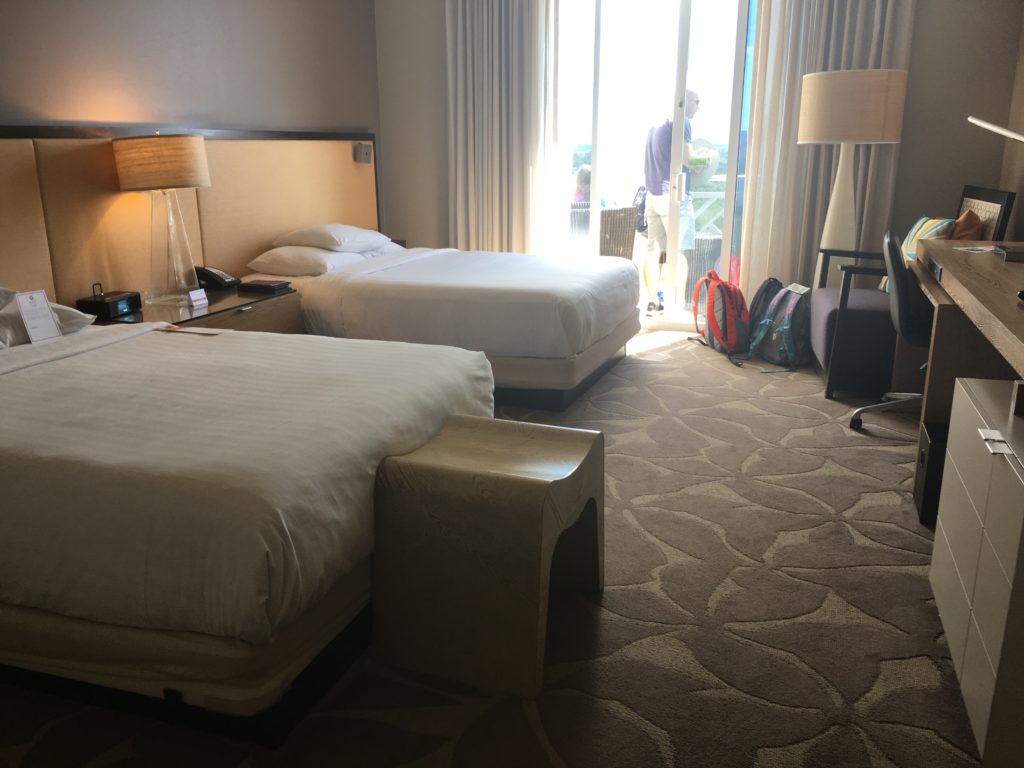 a hotel room with two beds and a table
