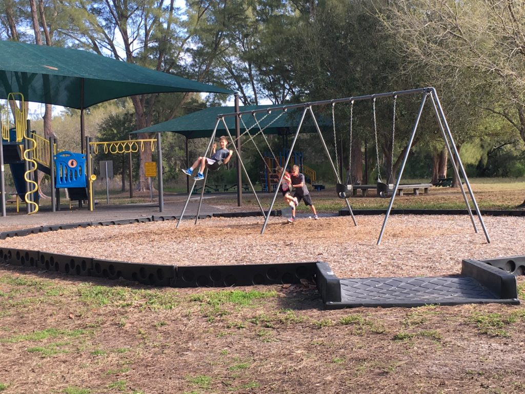 a group of people on a swing set