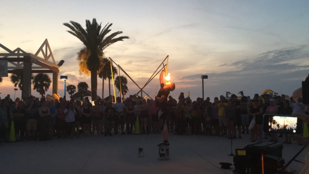 a person performing with fire in front of a crowd of people