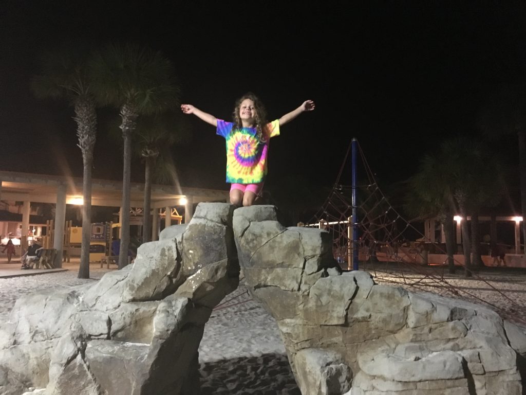 a girl sitting on a rock