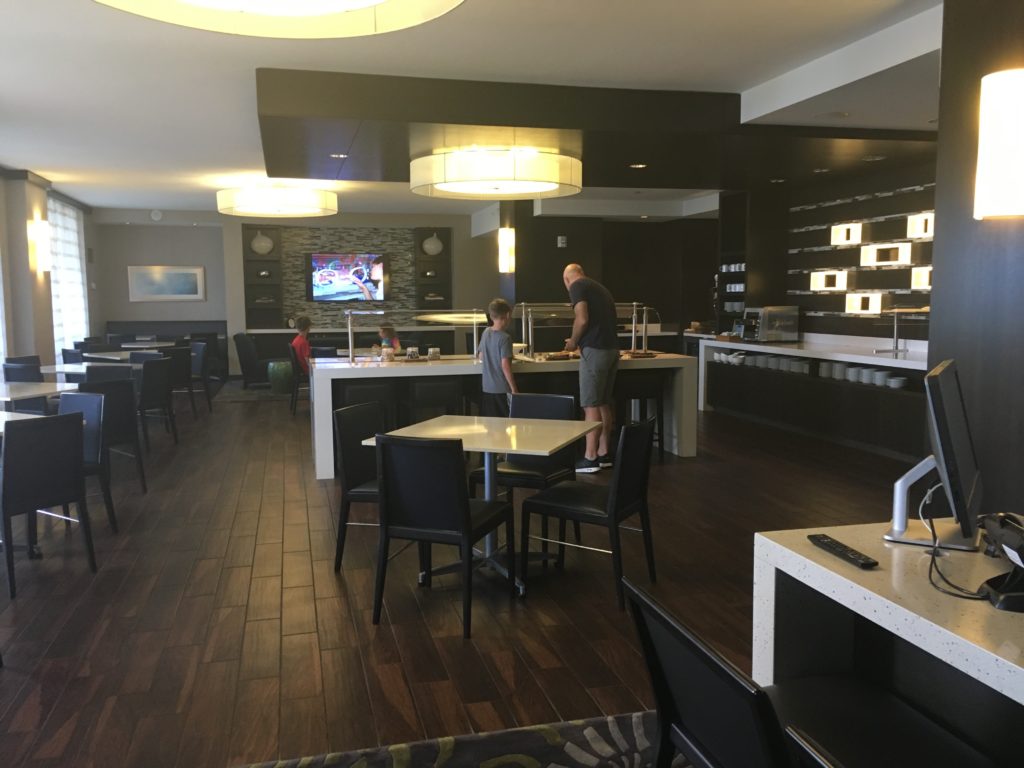 a man and boy standing in a restaurant