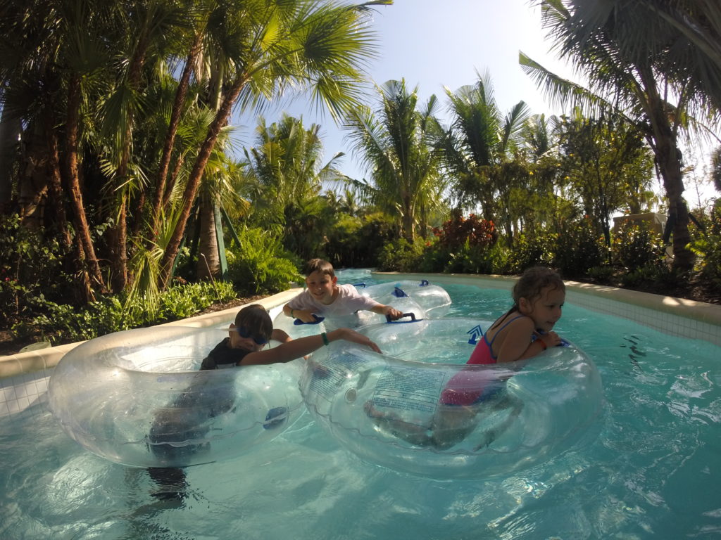 a group of people in clear tubes in a pool