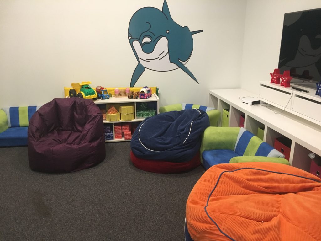 a room with bean bags and a cartoon whale on the wall