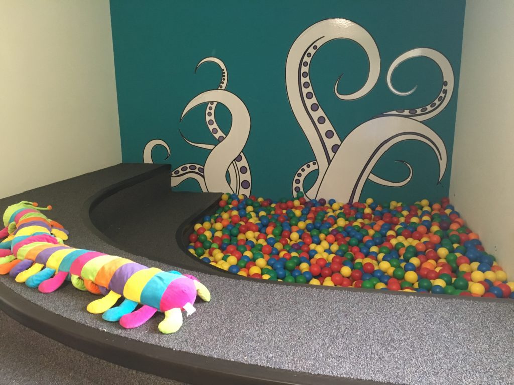 a toy stuffed animal next to a ball pit