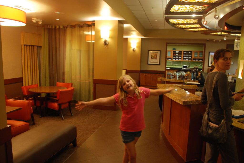 a girl standing in a hotel lobby