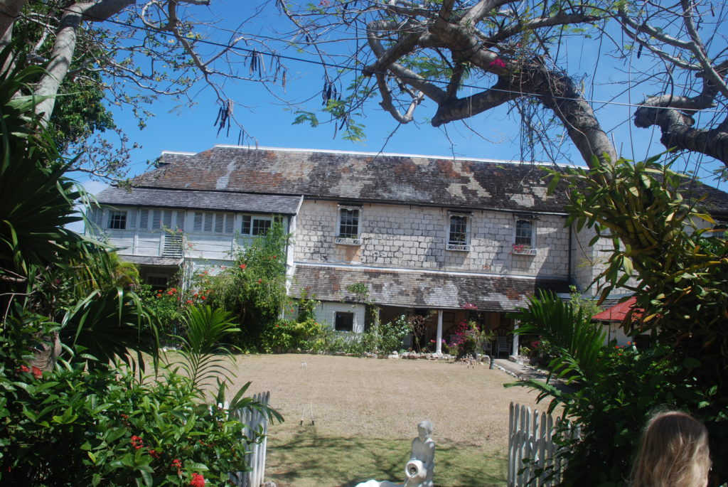 a large white building with a white fence and a white fence