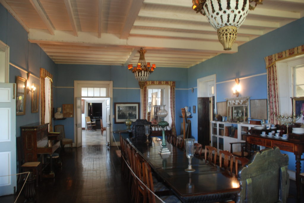 a room with a long table and chairs