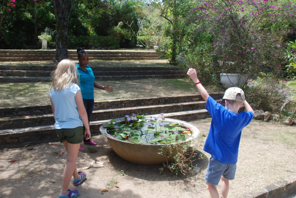 a group of people standing around a bowl of water