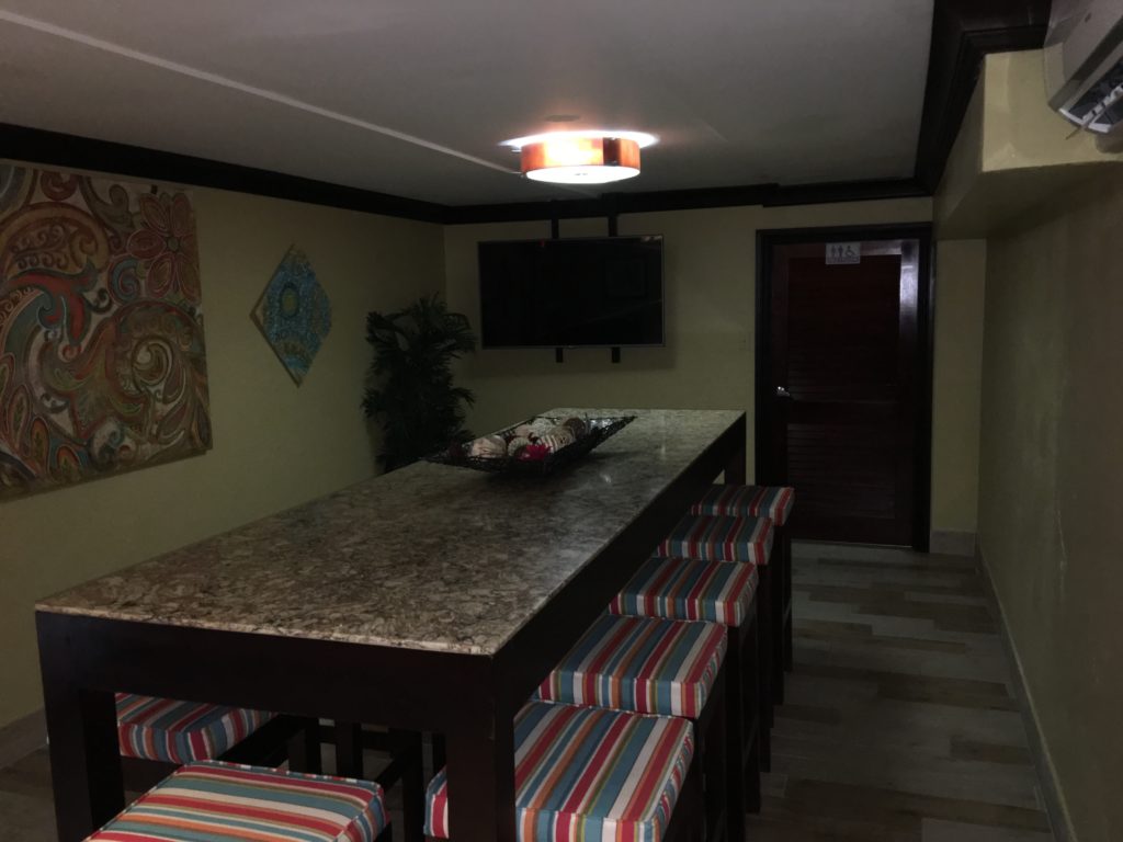 a table with chairs and a television in the background