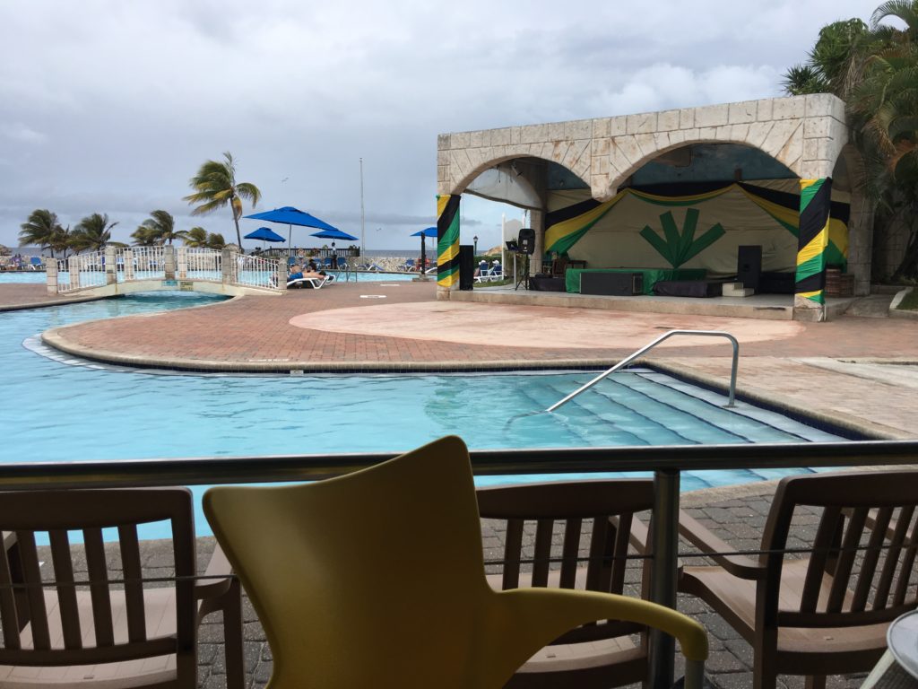 a pool with chairs and a stage
