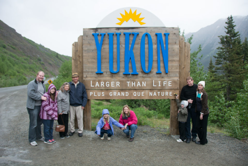 a group of people posing for a photo in front of a sign