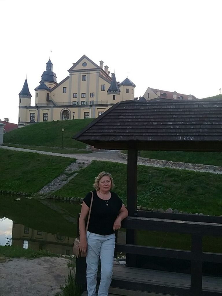 a woman standing next to a bridge