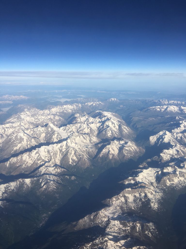 a aerial view of mountains and blue sky