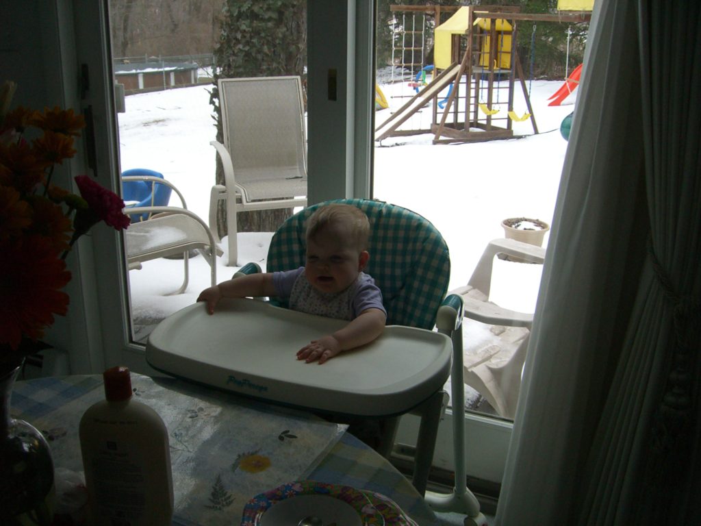 a baby sitting in a highchair