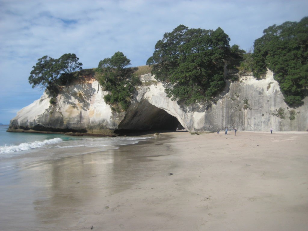 a large rock formation on a beach